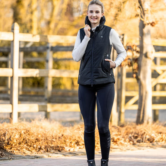 woman wearing HKM Rio Full Seat Riding Tights and black HKM Vest