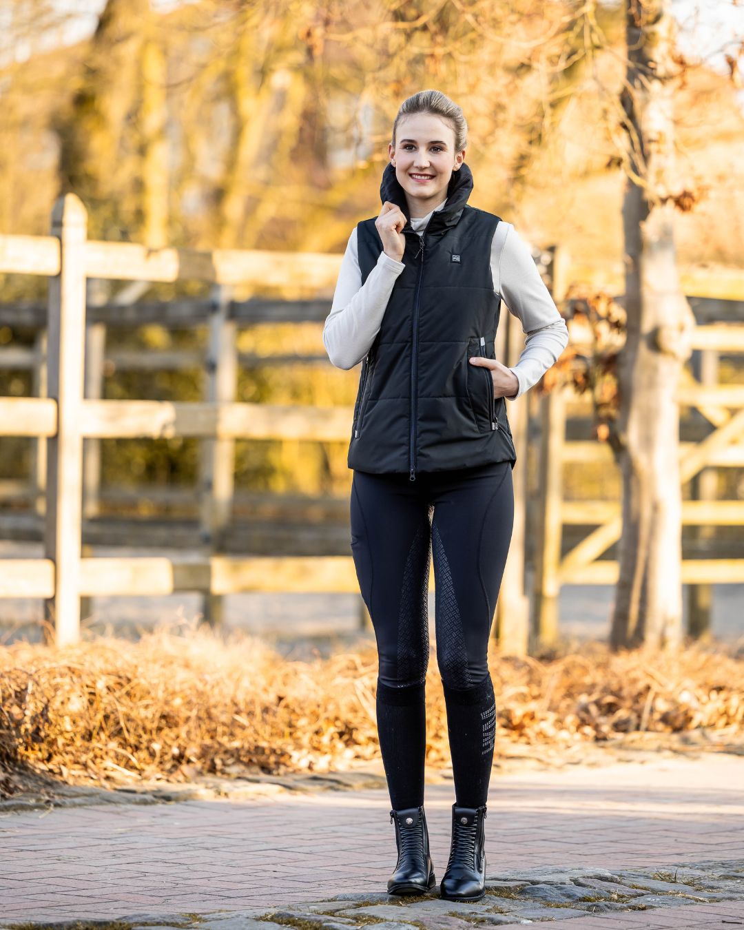 woman wearing HKM Rio Full Seat Riding Tights and black HKM Vest