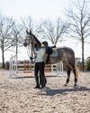 Person wearing HKM Supersoft II Functional 1/4 Zip Shirt in sage next to a horse