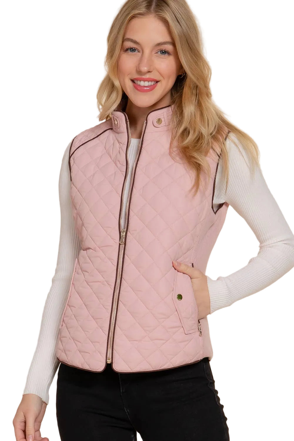 Woman wearing a pink quilted vest on a white background equestrian fashion outfitters