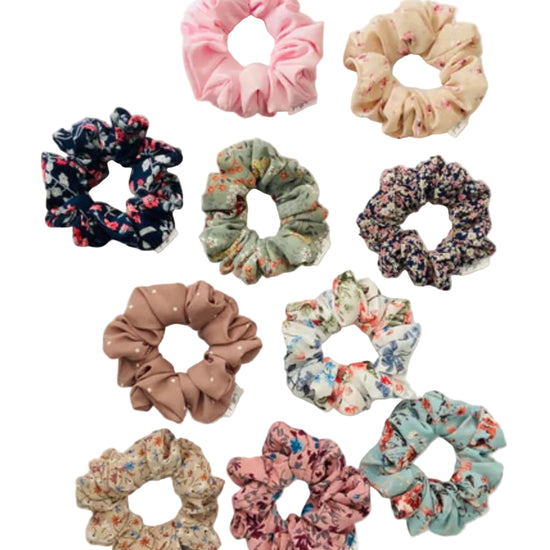 Assorted floral and polka dot scrunchies on a light background