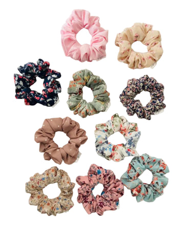 Assorted floral and polka dot scrunchies on a light background