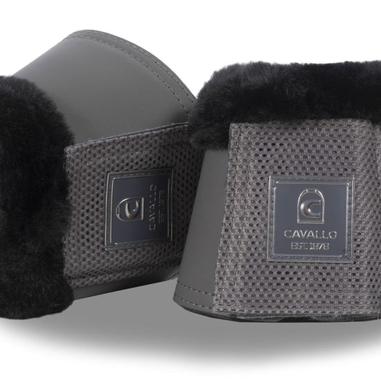 Pair of black and gray equestrian bell boots with brand logo on a white background