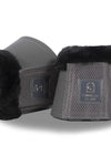 Pair of black and gray equestrian bell boots with brand logo on a white background
