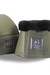 Green equestrian bell boots with black fur lining on a white background