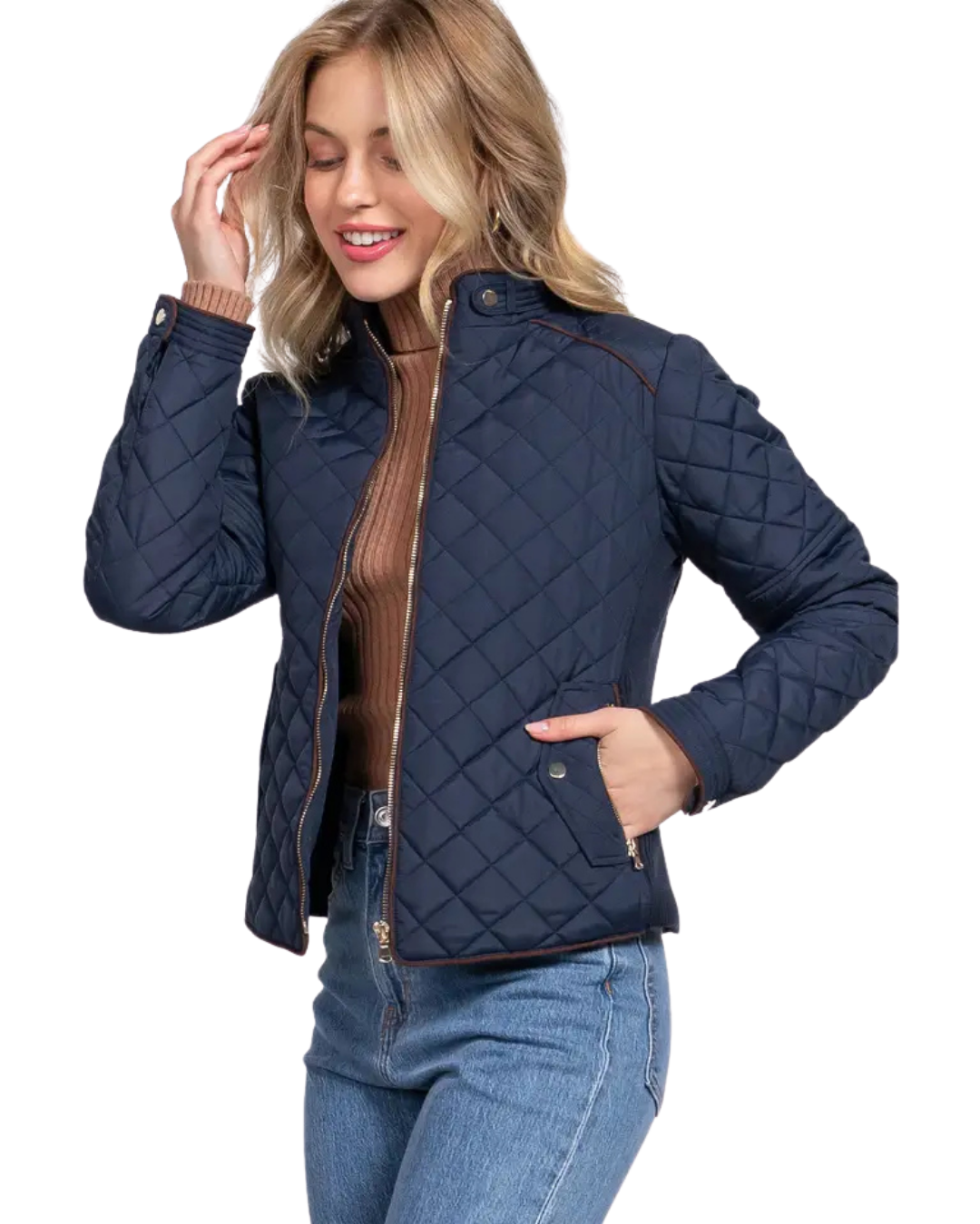 A woman modeling a navy blue diamond-quilted jacket with brown trim over a brown ribbed turtleneck and blue jeans, set against a plain white background equestrian fashion outfitters
