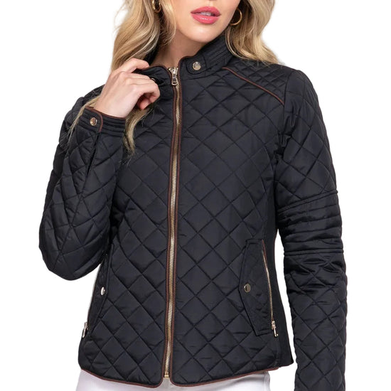 Woman wearing a black quilted jacket on a white background equestrian fashion outfitters