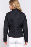 Person wearing a black quilted jacket on a white background equestrian fashion outfitters