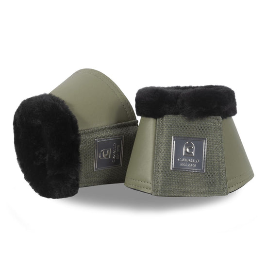 Two green horse bell boots with black fur trim on a white background