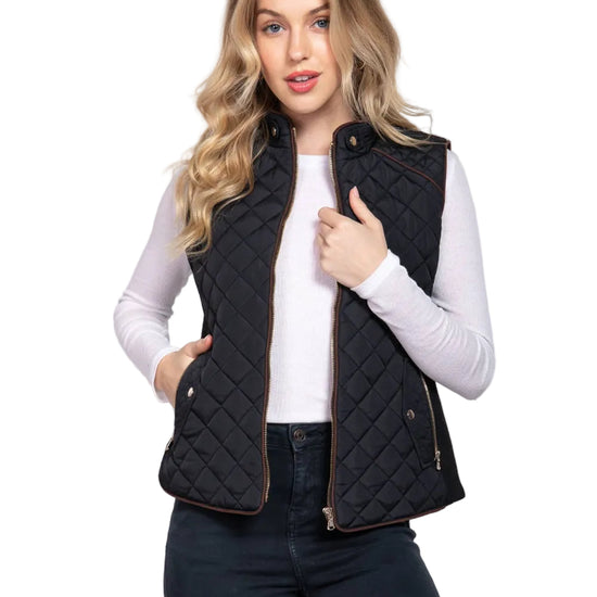 Woman wearing a black quilted vest on a white background equestrian fashion outfitters