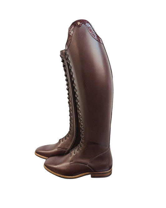 A pair of dark brown  oxblood leather tall riding boots with lace-up front and a side zipper, shown from a side profile view on a white background.equestrian fashion outfitters