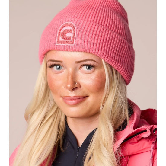 woman wearing a pink hat with a pink jacket hat has a C logo