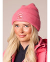 woman wearing a pink hat with a pink jacket hat has a C logo