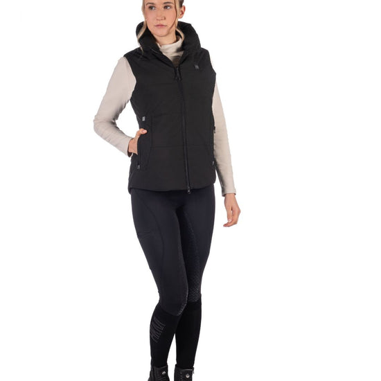 Woman wearing a Black HKM Canada Heated Vest and a light gray long-sleeve shirt on a white background