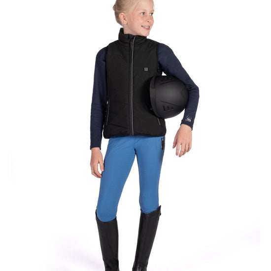 Child wearing HKM Childrens Black heated vest with logo on a white background equestrian fashion outfitters