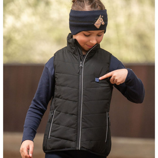 Child wearing HKM Childrens Black heated vest with logo on a white background - equestrian fashion outfitters