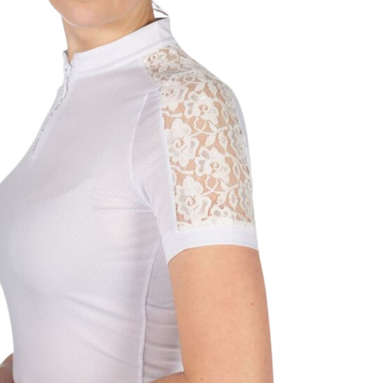White equestrian top with lace sleeves worn by a person on a white background