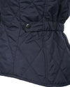 Navy quilted jacket with a snap on a white background