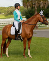 Person riding a brown horse with a white saddle pad