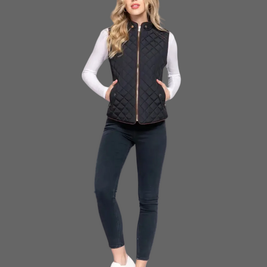 Woman wearing a black quilted vest over a white long-sleeve shirt on a white background equestrian fashion outfitters