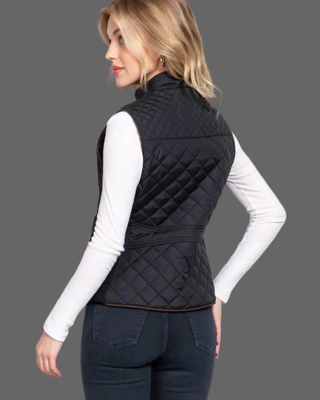 Woman wearing a black quilted vest on a white background equestrian fashion outitters