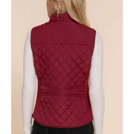 Red quilted vest worn by a person on a beige background equestrian fashion outfitters