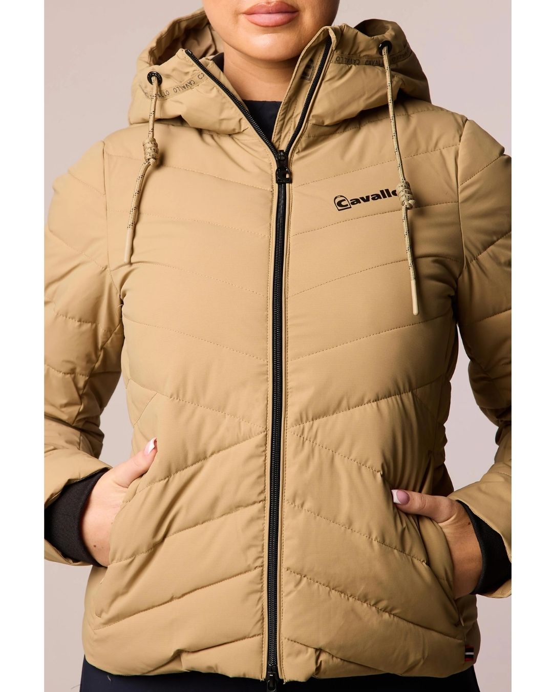 Beige puffer jacket with a brand logo on a neutral background