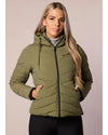 Woman wearing a green puffer jacket with a neutral background