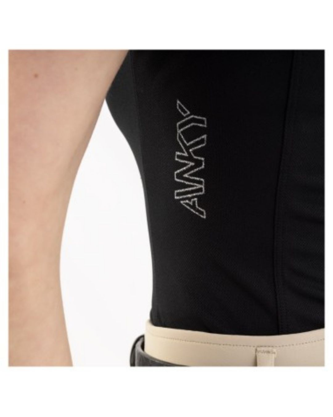Black sleeveless top with 'ANKY' branding on a person wearing beige breeches pants. equestrian fashion outfitters