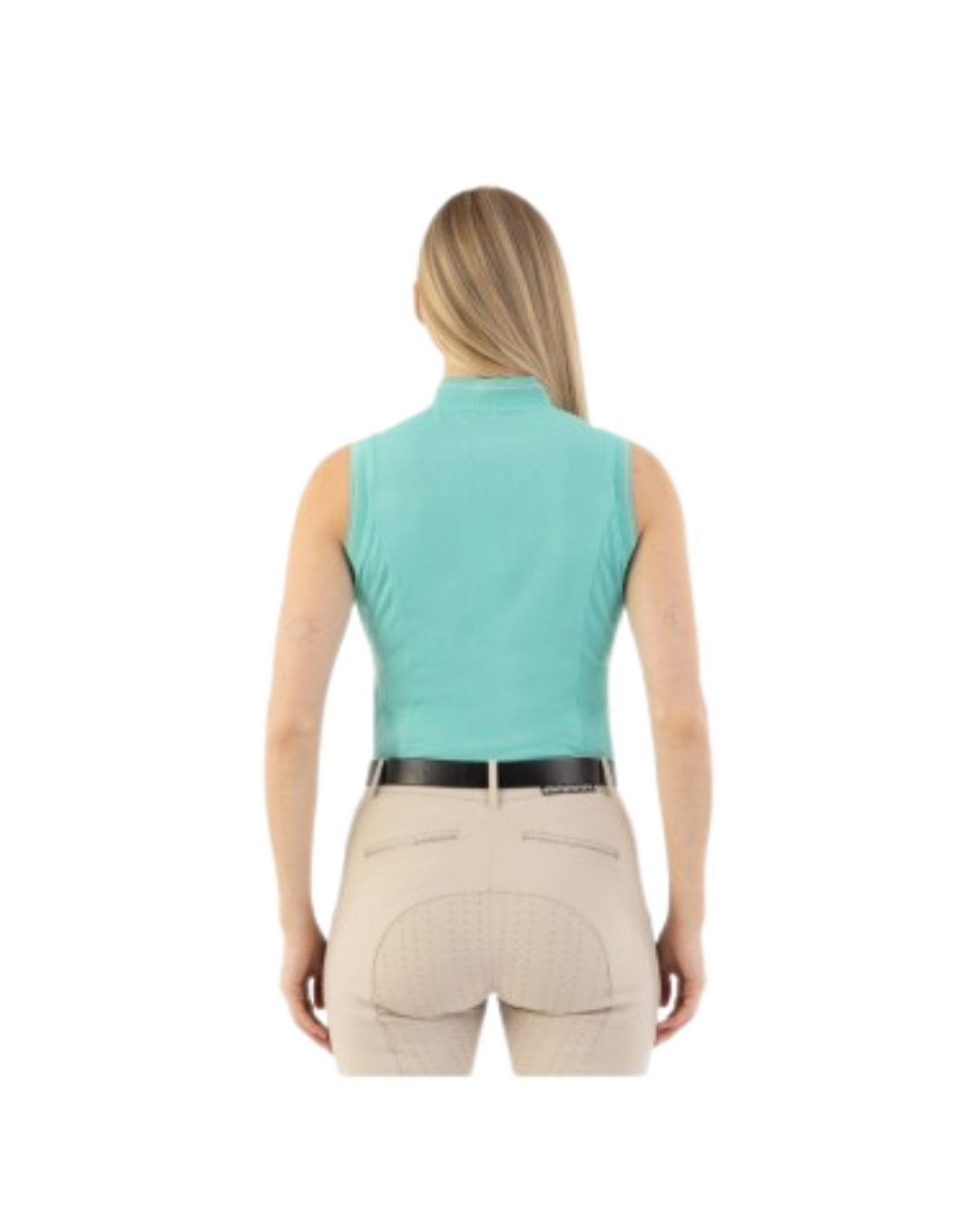 Woman wearing a light blue sleeveless top and beige pants on a white background equestrian fashion outfitters