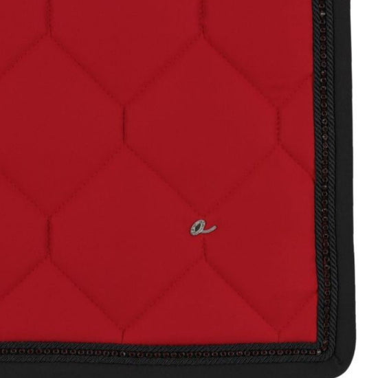 Red quilted mat with black border on a white background