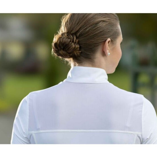 Person wearing a white shirt with a blurred outdoor background Equestrian fashion outfitters