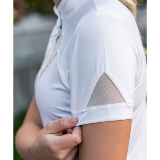 White shirt with sheer sleeves worn by a person, blurred background Equestrian fashion outfitters