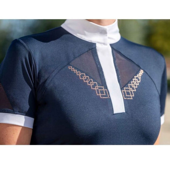 Navy blue top with white collar and geometric embroidery on a blurred outdoor background Equestrian fashion outfitters