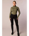Person wearing a green turtleneck and black pants on a plain background