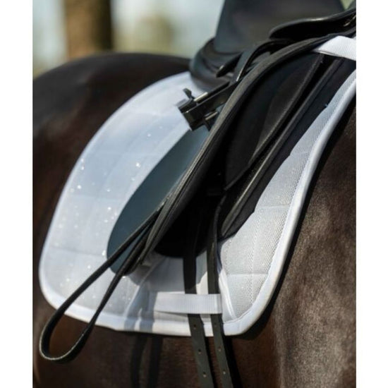 black saddle with HKM Glitter mesh quilted white saddle pad on a horse