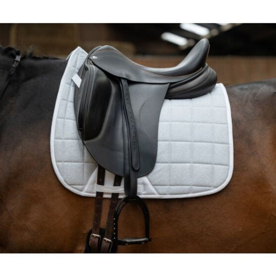 black saddle with HKM Glitter mesh quilted white saddle pad on a horse
