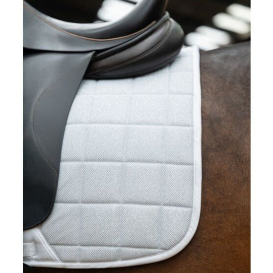 close up of black saddle with HKM Glitter mesh quilted white saddle pad on a horse 