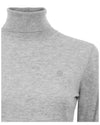 Gray turtleneck sweater with a brand logo on a white background