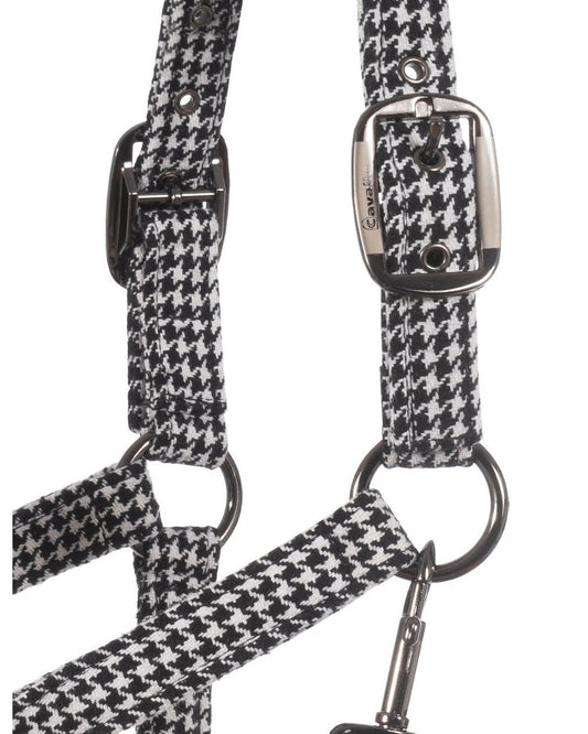 Houndstooth patterned strap with metal hardware on a white background