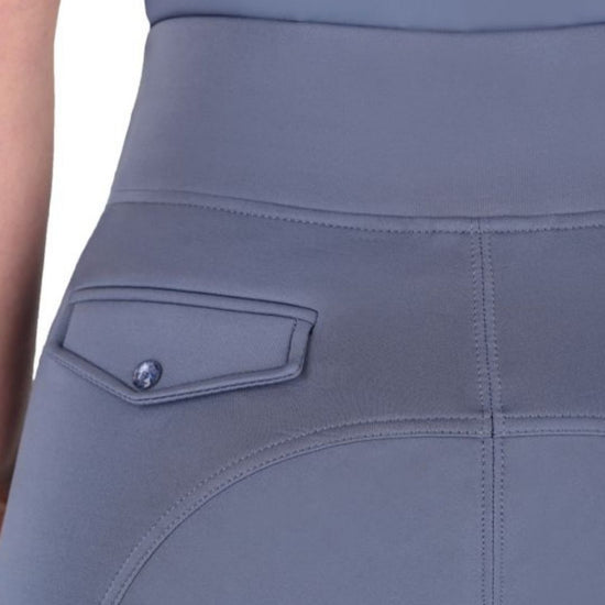 Close-up of a grey blue breeches with a pocket detail on a plain background equestrian fashion outfitters