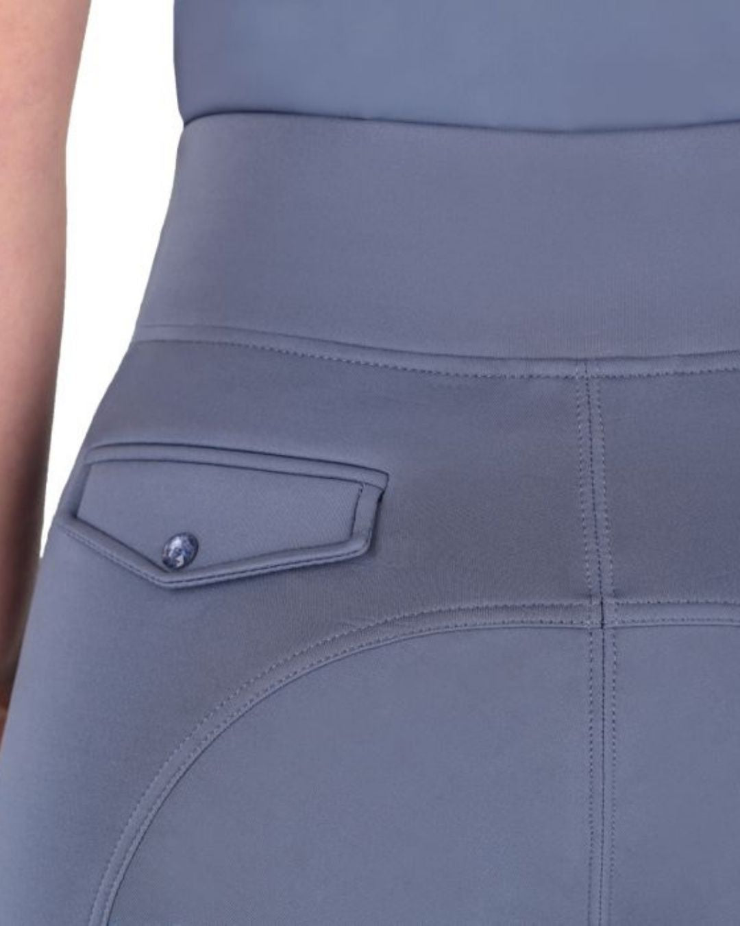 Close-up of a grey blue breeches with a pocket detail on a plain background equestrian fashion outfitters