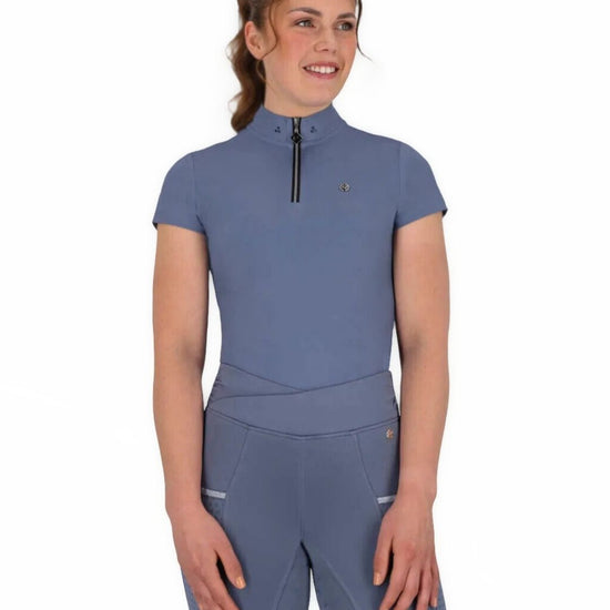 Woman wearing a blue qhp short sleeve training shirt on a white background equestrian fashion outfitters