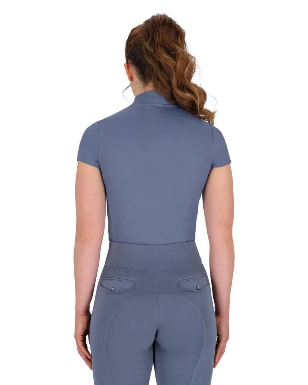Person wearing a blue short sleeve equestrian outfit on a white background equestrian fashion outfitters