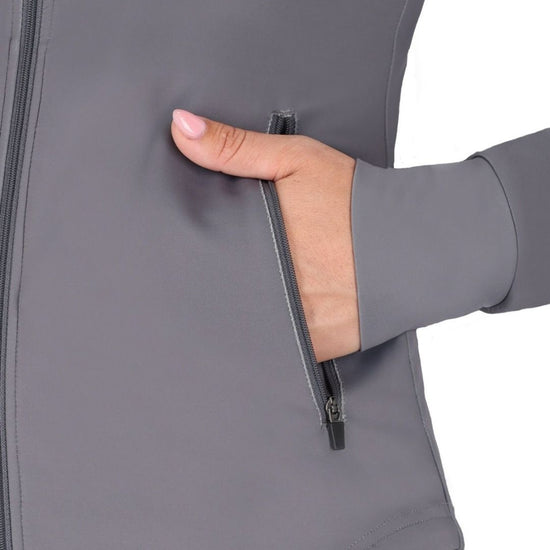 Hand zipping a gray jacket on a white background equestrian fashion outfitters