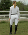 Person wearing equestrian attire in a grassy field equestrian fashion outfitters