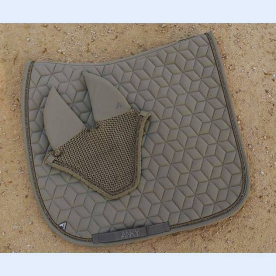 Quilted saddle pad with a ear bonnet on a beige  khaki background