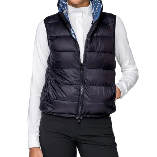 Person wearing a black puffer vest over a white shirt on a white background kastel equestrian fashion outfitters