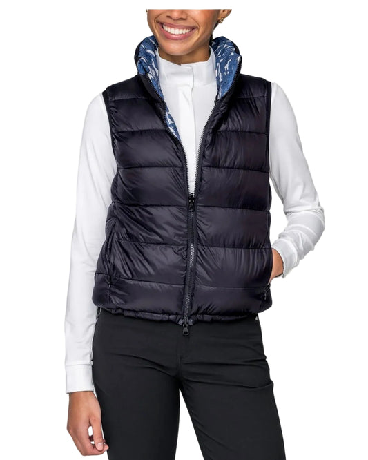 Person wearing a black puffer vest over a white shirt on a white background kastel equestrian fashion outfitters