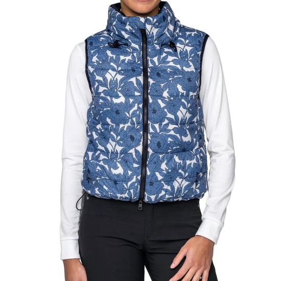 Person wearing a blue patterned puffer vest over a white shirt on a white background kastel equestrian fashion outfitters